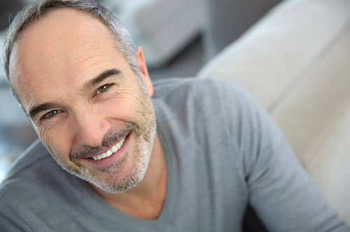 Man smiling after getting veneers